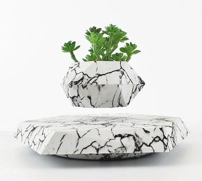 Levitating marble bonsai pot floating above magnetic base