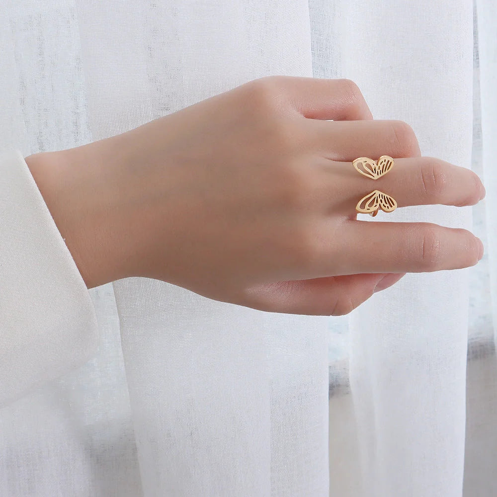 Adjustable hollow butterfly ring in titanium steel, available in golden and steel colours.