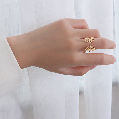 Adjustable hollow butterfly ring in titanium steel, available in golden and steel colours.