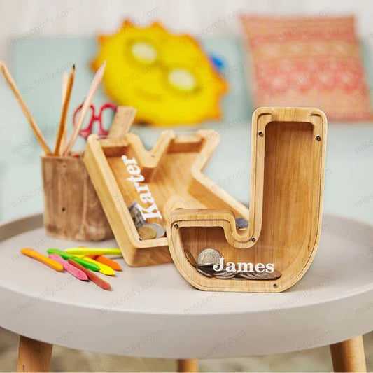 Personalized letter-shaped wooden money bank with clear viewing window for tracking savings progress