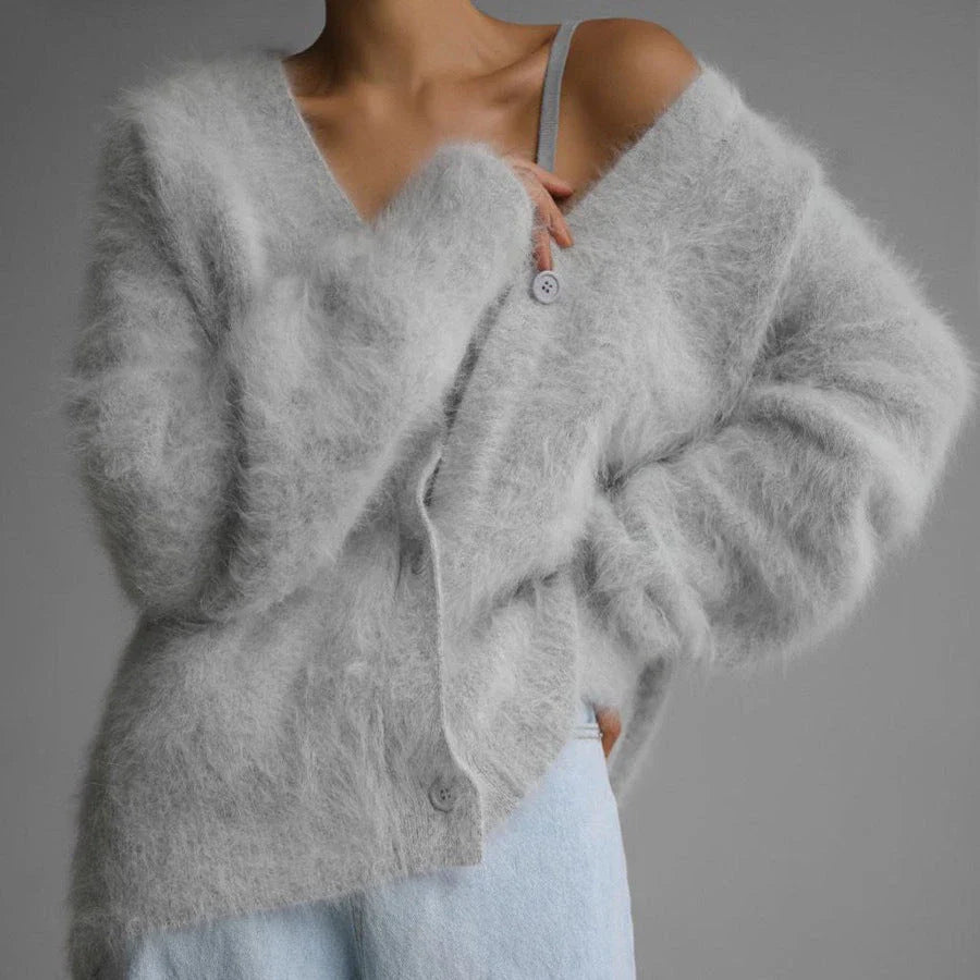 A stylish loose knit cardigan in a variety of colors, featuring a v-neck design and single-breasted closure for a flattering, relaxed fit.