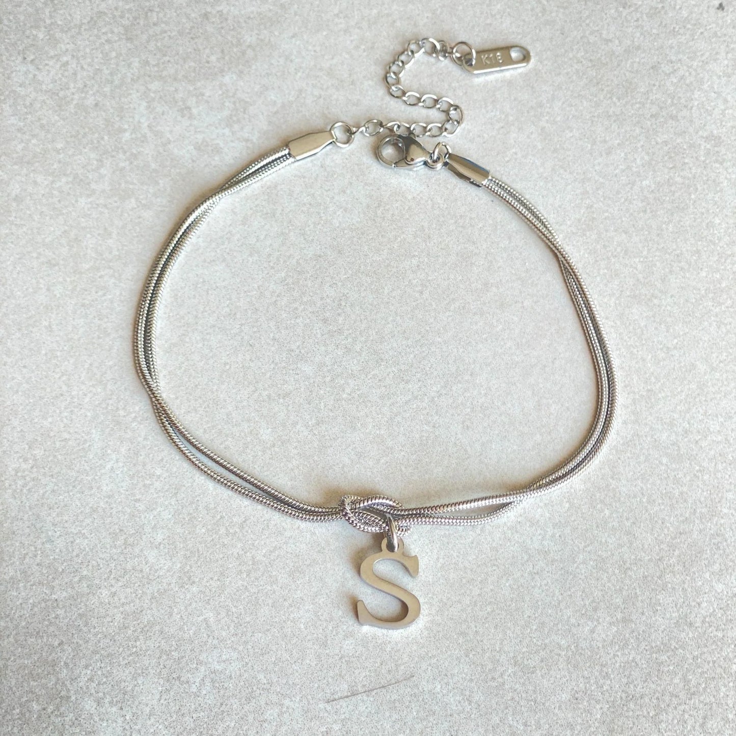 Personalised gold and silver love knot bracelets for couples, perfect as Valentine's Day gifts.
