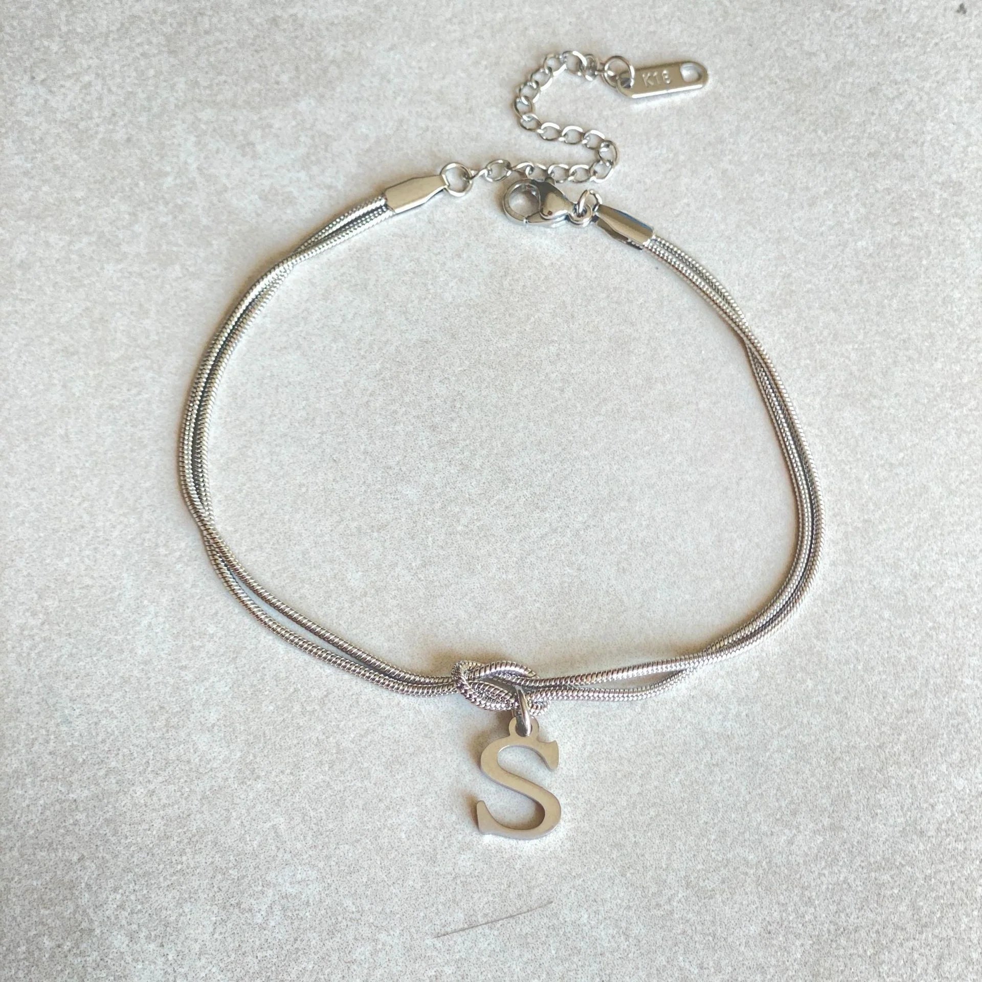 Personalised gold and silver love knot bracelets for couples, perfect as Valentine's Day gifts.