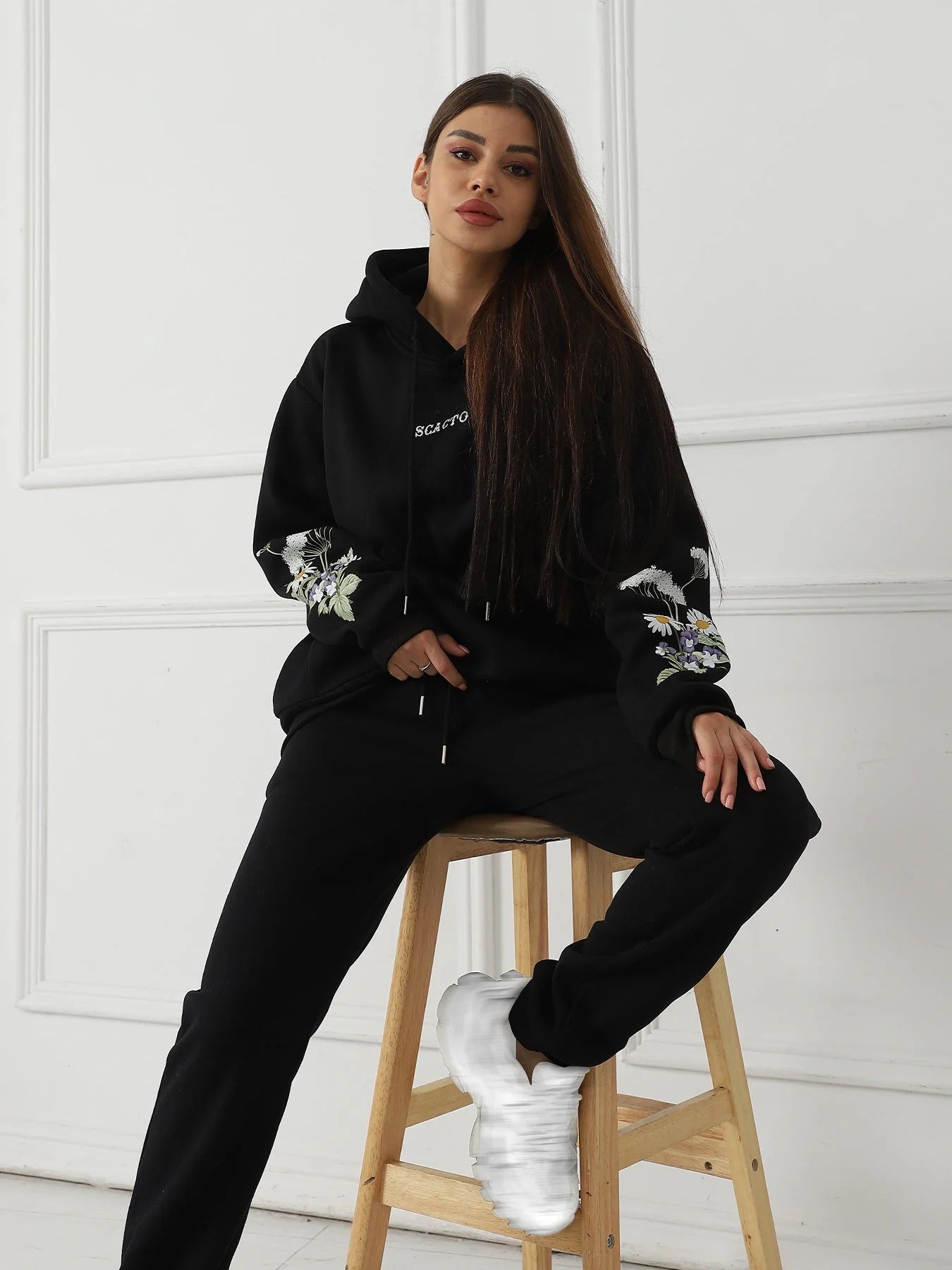 Women's floral long sleeved sweatshirt in black, blue, and apricot