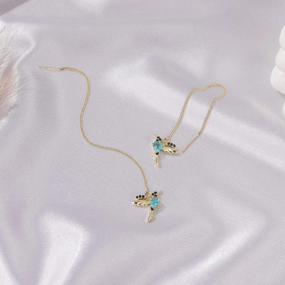 Elegant hummingbird drop earrings with crystal accents, a versatile fashion accessory for British women