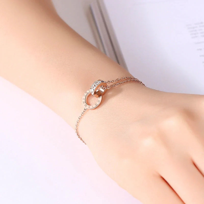 Rose gold titanium steel bracelet with zircon inlay and roman numeral detailing
