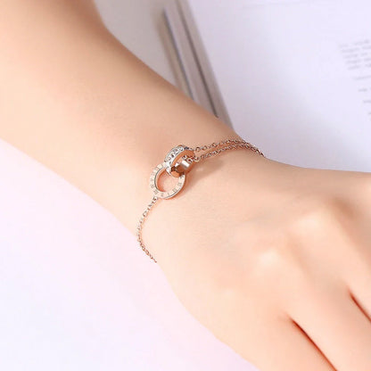 Rose gold titanium steel bracelet with zircon inlay and roman numeral detailing