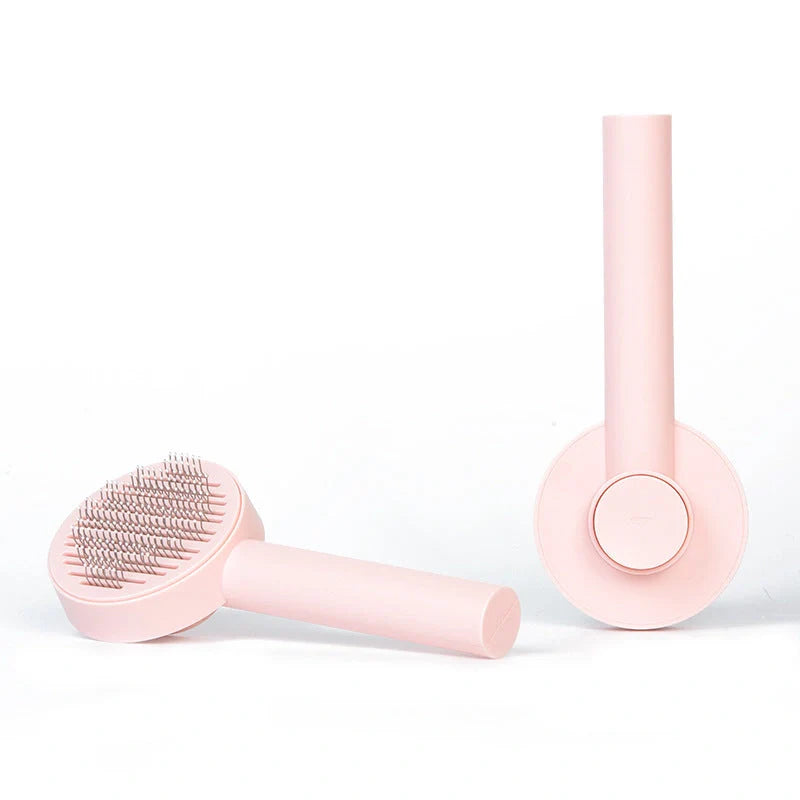 Self-cleaning pet grooming comb with stainless steel needles in blue, pink, and white