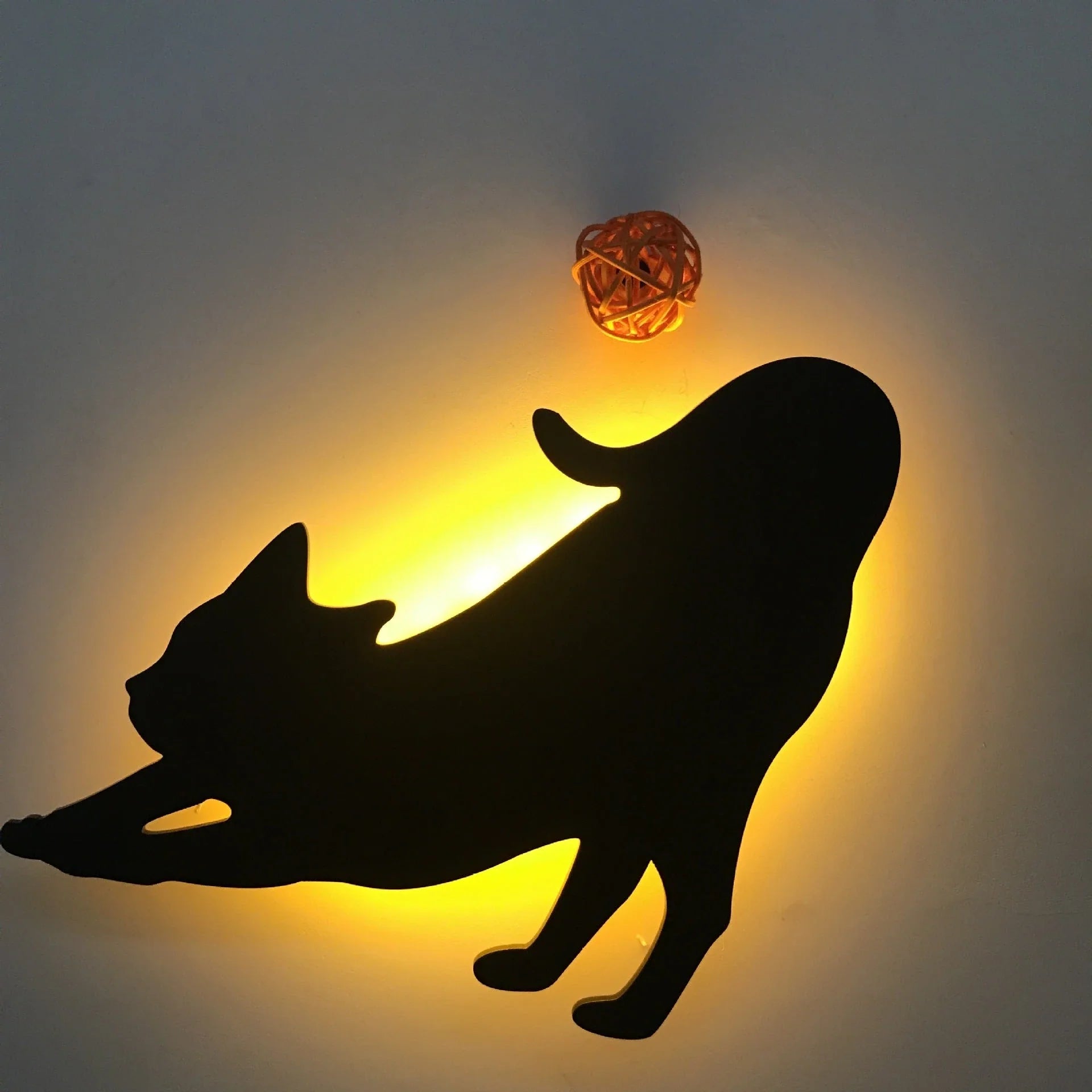 A stylish cat-shaped smart sensor night light that automatically illuminates a room when motion is detected, creating a warm and cozy atmosphere.