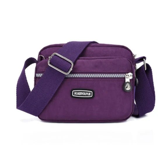 Small square messenger bag in water-repellent nylon with multi-compartment design