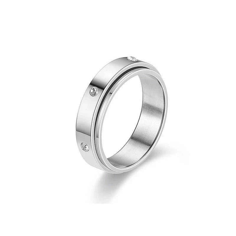 Elegant stainless steel spinner ring with a captivating moon and star design that rotates effortlessly for a calming tactile experience