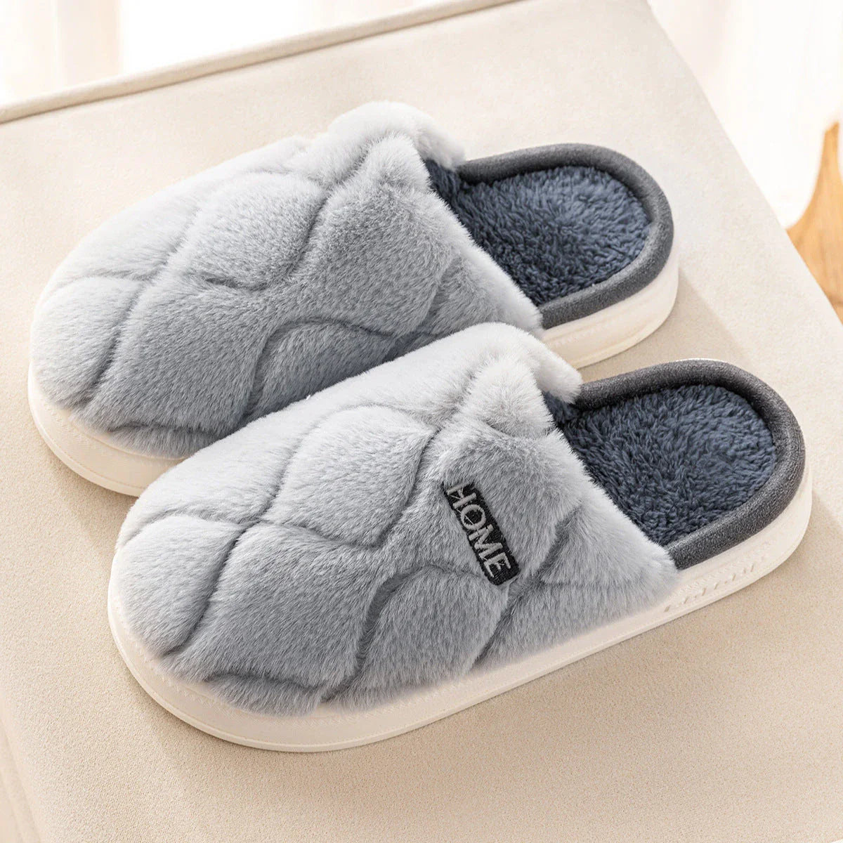 Plush slippers with soft, cushiony upper and durable PVC sole for cozy indoor comfort and traction