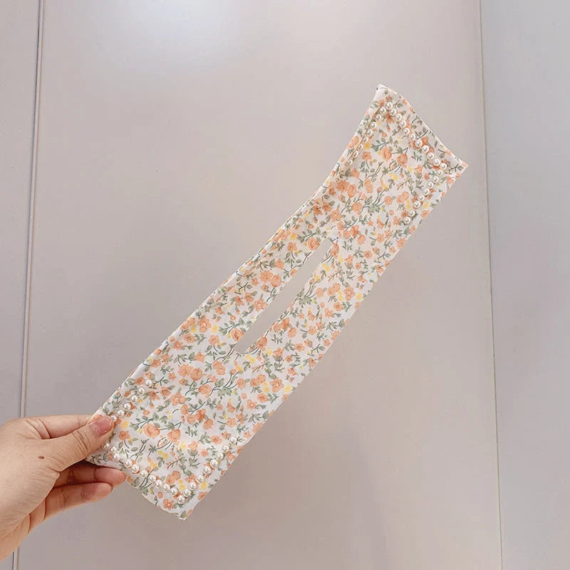 Women's elegant cloth headband with diamond and pearl accents for stylish hairstyles