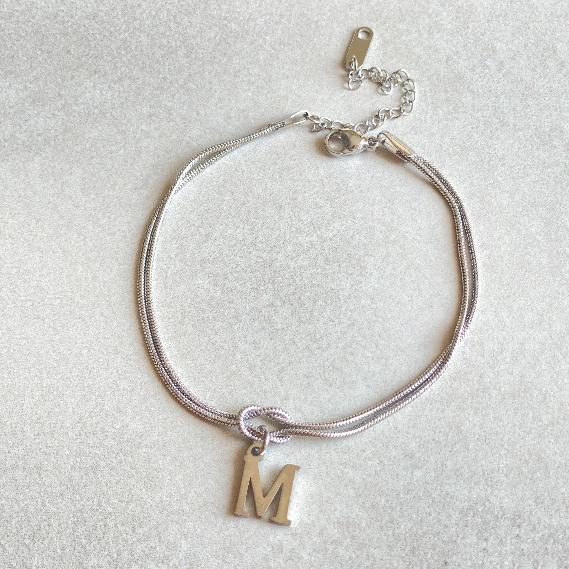Personalised gold and silver love knot bracelets for couples, perfect as Valentine's Day gifts.