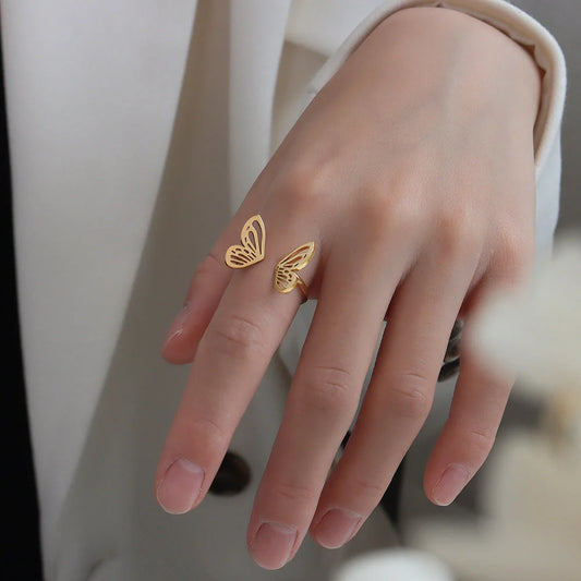 Adjustable hollow butterfly ring in titanium steel, available in golden and steel colours.