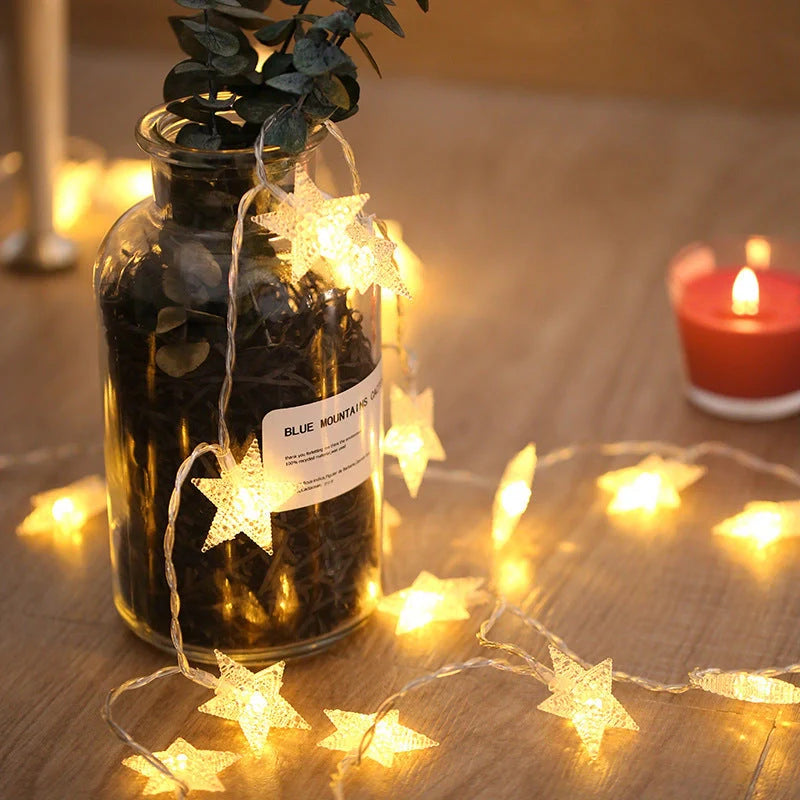 Battery-operated LED curtain garland with plastic stars and fur balls for festive decoration