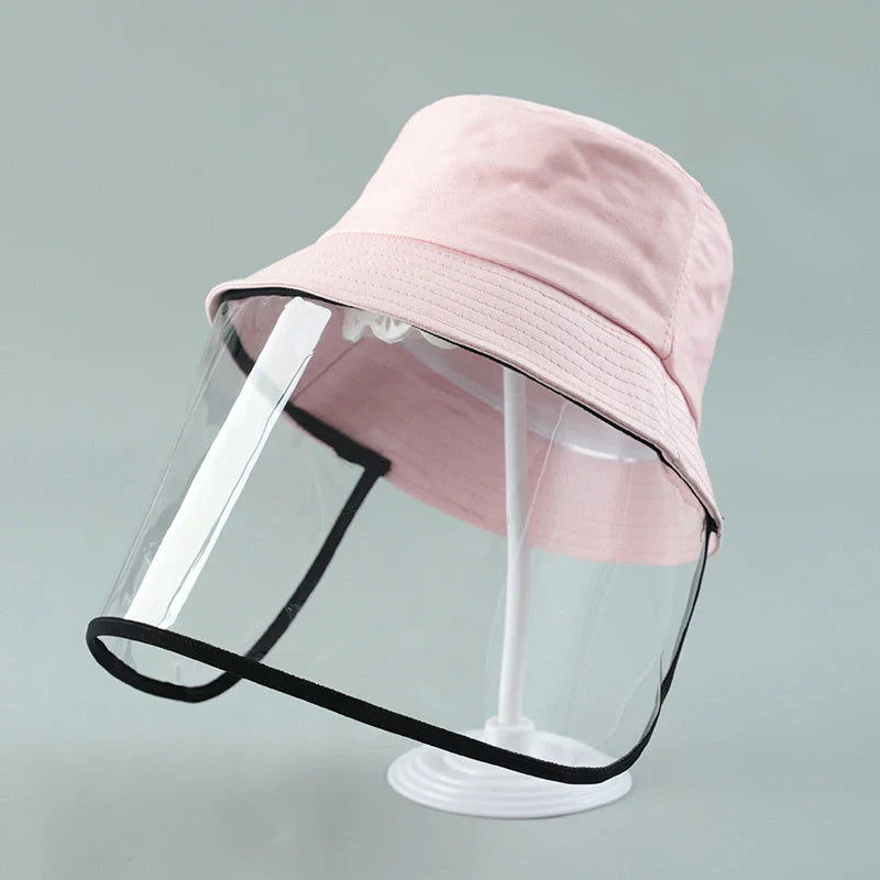 Child wearing anti-spitting protective hat with transparent bezel