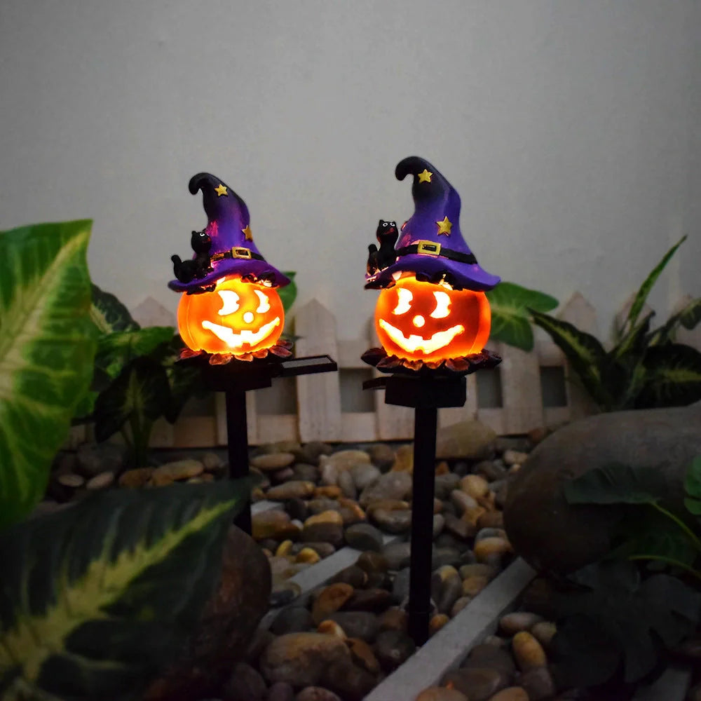 Solar-powered Halloween pumpkin lanterns in garden setting