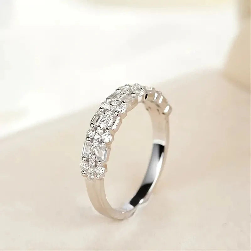 Elegant multilayer ring with a subtle geometric design, available in platinum, gold, and rose gold colours
