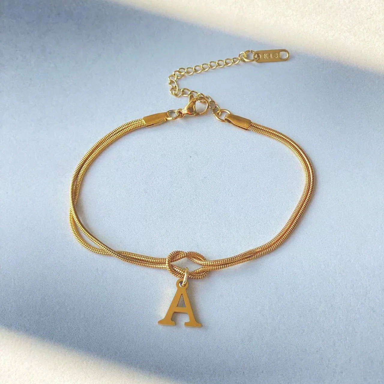 Personalised gold and silver love knot bracelets for couples, perfect as Valentine's Day gifts.