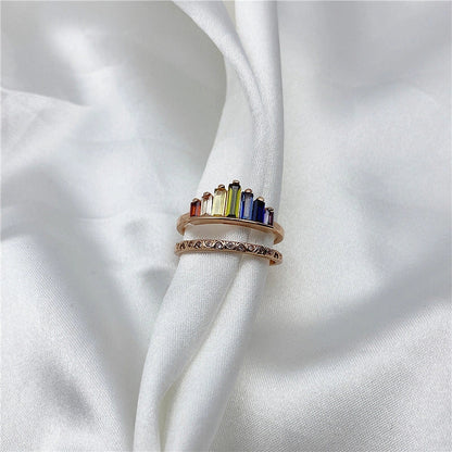 Stylish rainbow micro-diamond ring with a geometric design, available in silver and rose gold finishes