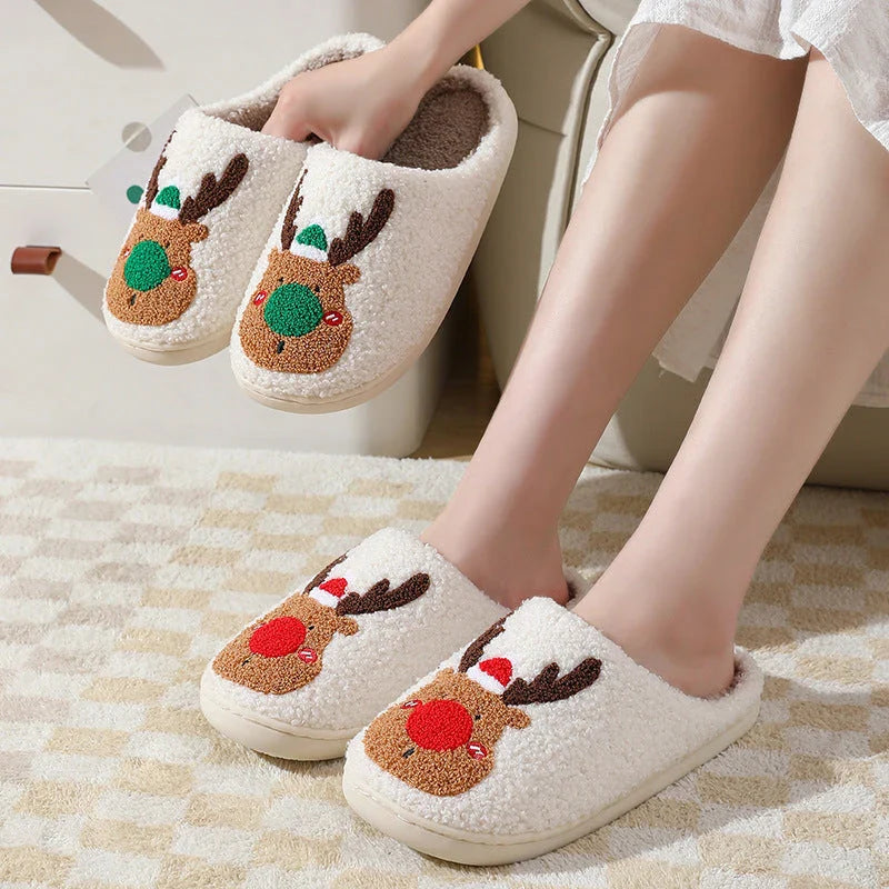Cozy elk-themed slip-on house slippers in festive red and green colors with plush, soft materials for comfortable holiday relaxation