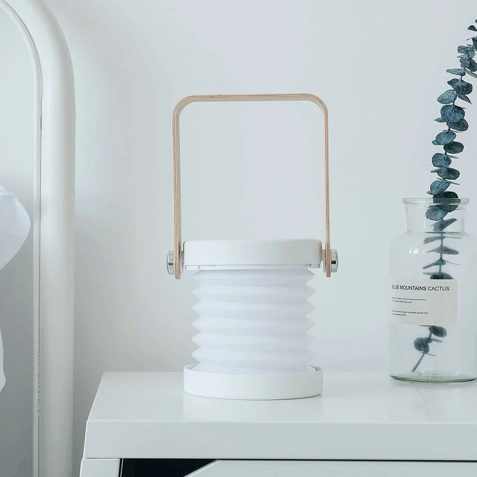 Elegant foldable LED lamp with touch-controlled dimming, rechargeable battery, and modern design for home decor