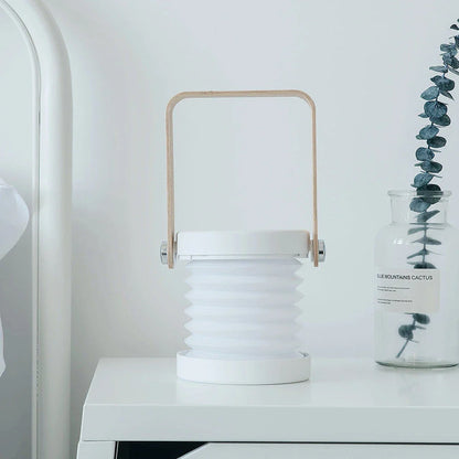 Elegant foldable LED lamp with touch-controlled dimming, rechargeable battery, and modern design for home decor