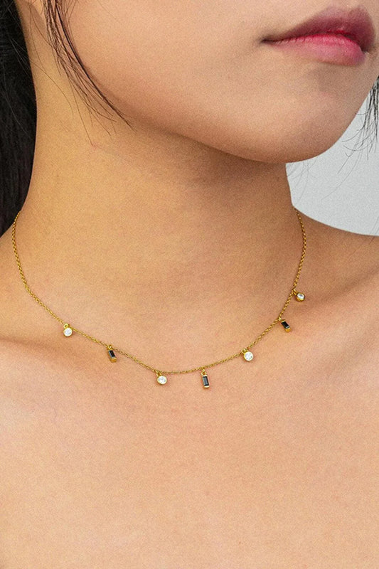 Elegant 18K gold-plated multi-charm chain necklace with delicate charms and a minimalist design