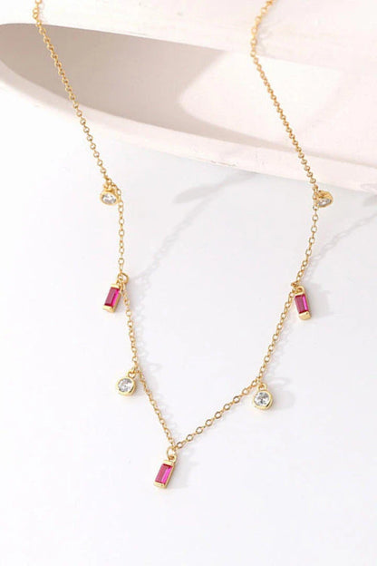 Elegant 18K gold-plated multi-charm chain necklace with delicate charms and a minimalist design