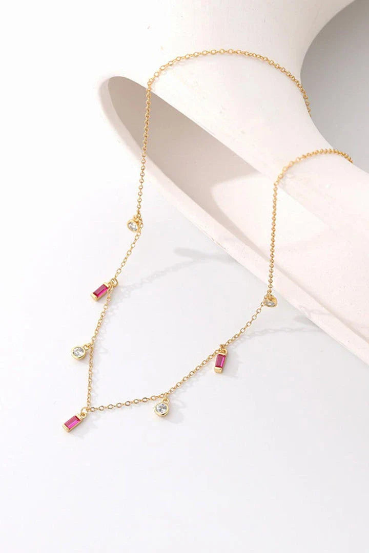 Elegant 18K gold-plated multi-charm chain necklace with delicate charms and a minimalist design