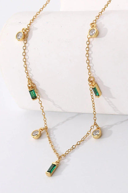 Elegant 18K gold-plated multi-charm chain necklace with delicate charms and a minimalist design