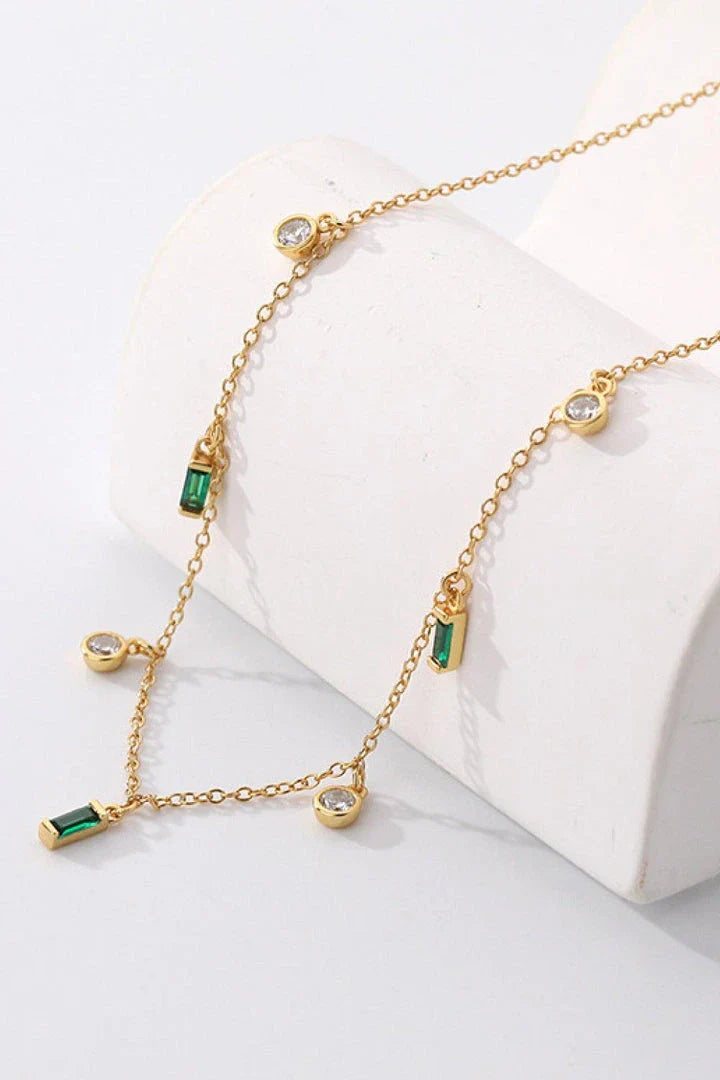 Elegant 18K gold-plated multi-charm chain necklace with delicate charms and a minimalist design