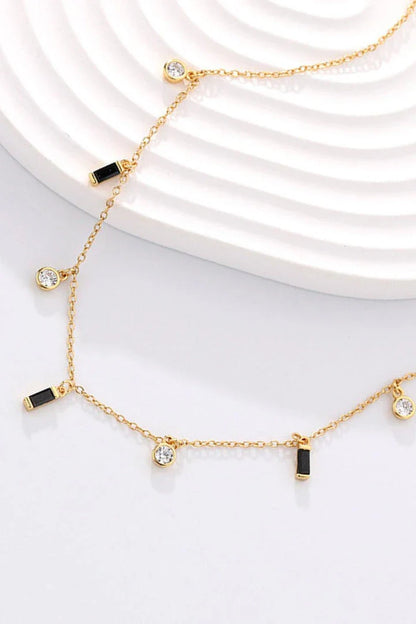 Elegant 18K gold-plated multi-charm chain necklace with delicate charms and a minimalist design