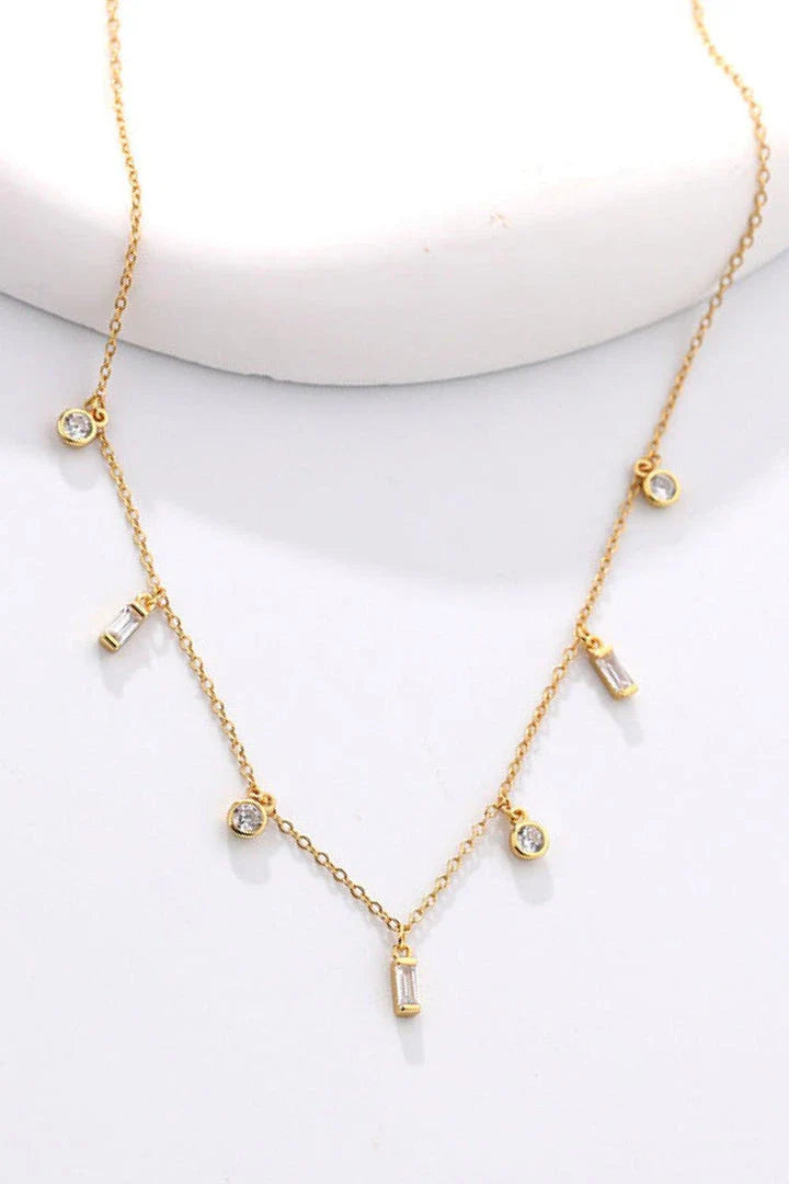 Elegant 18K gold-plated multi-charm chain necklace with delicate charms and a minimalist design