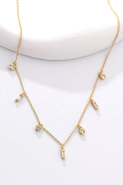 Elegant 18K gold-plated multi-charm chain necklace with delicate charms and a minimalist design