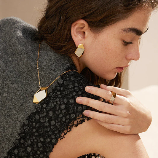 Close-up of a 18K gold-plated ring featuring a genuine meteorite insert with mesmerising natural patterns