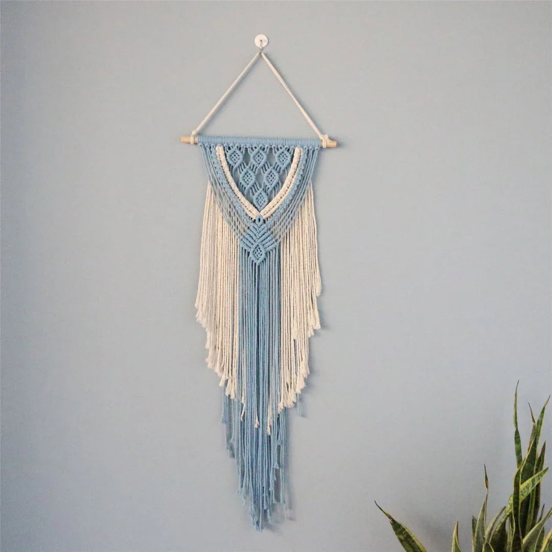 Hand-woven cotton string tapestry with blue and white colours, featuring playful tassels for a modern and rustic wall decoration