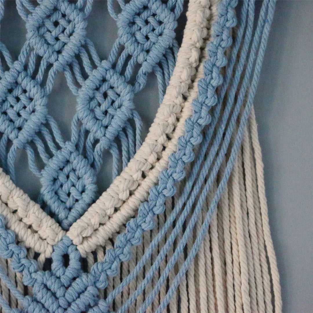 Hand-woven cotton string tapestry with blue and white colours, featuring playful tassels for a modern and rustic wall decoration