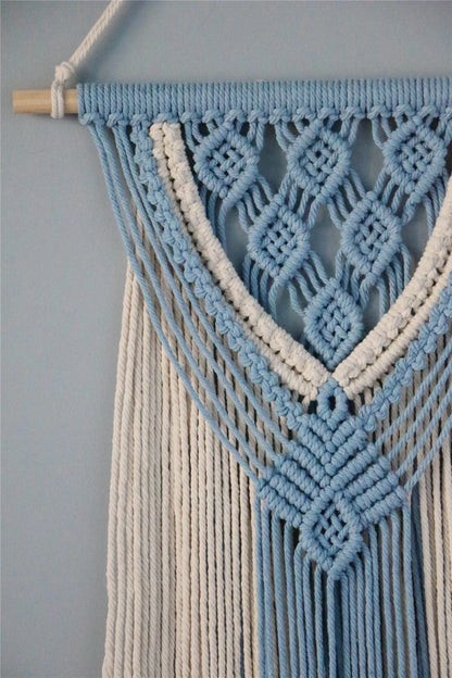 Hand-woven cotton string tapestry with blue and white colours, featuring playful tassels for a modern and rustic wall decoration