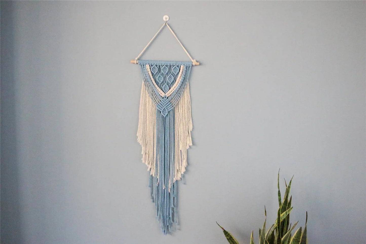 Hand-woven cotton string tapestry with blue and white colours, featuring playful tassels for a modern and rustic wall decoration