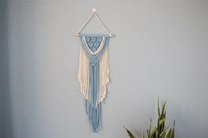 Hand-woven cotton string tapestry with blue and white colours, featuring playful tassels for a modern and rustic wall decoration