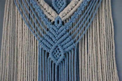 Hand-woven cotton string tapestry with blue and white colours, featuring playful tassels for a modern and rustic wall decoration
