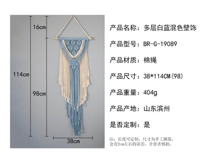 Hand-woven cotton string tapestry with blue and white colours, featuring playful tassels for a modern and rustic wall decoration