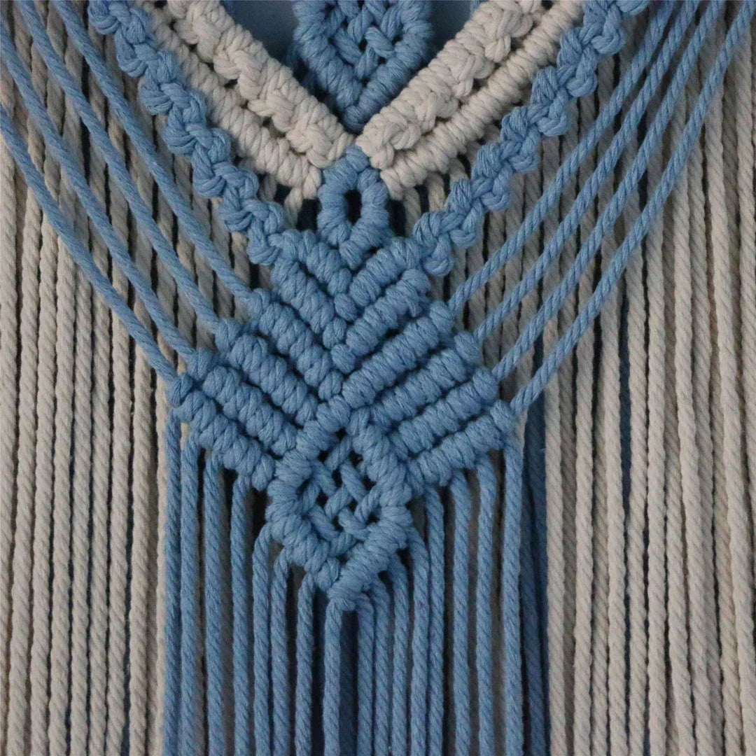 Hand-woven cotton string tapestry with blue and white colours, featuring playful tassels for a modern and rustic wall decoration