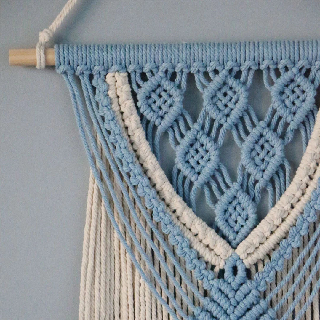 Hand-woven cotton string tapestry with blue and white colours, featuring playful tassels for a modern and rustic wall decoration