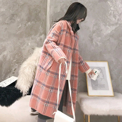 A cosy, thick knitted sweater coat in a classic plaid pattern, featuring a luxurious mink hair blend for superior softness and warmth.