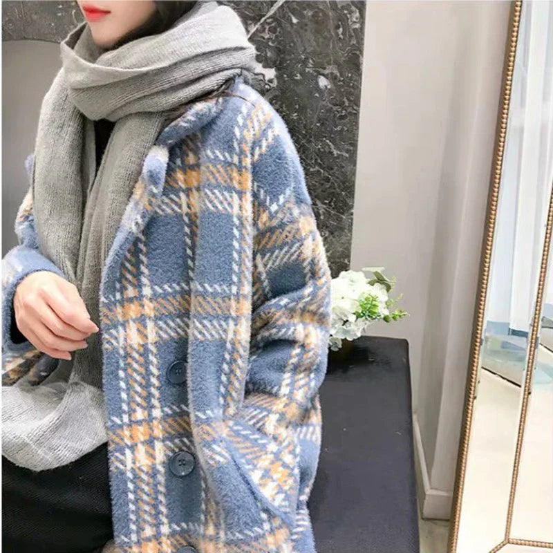 A cosy, thick knitted sweater coat in a classic plaid pattern, featuring a luxurious mink hair blend for superior softness and warmth.