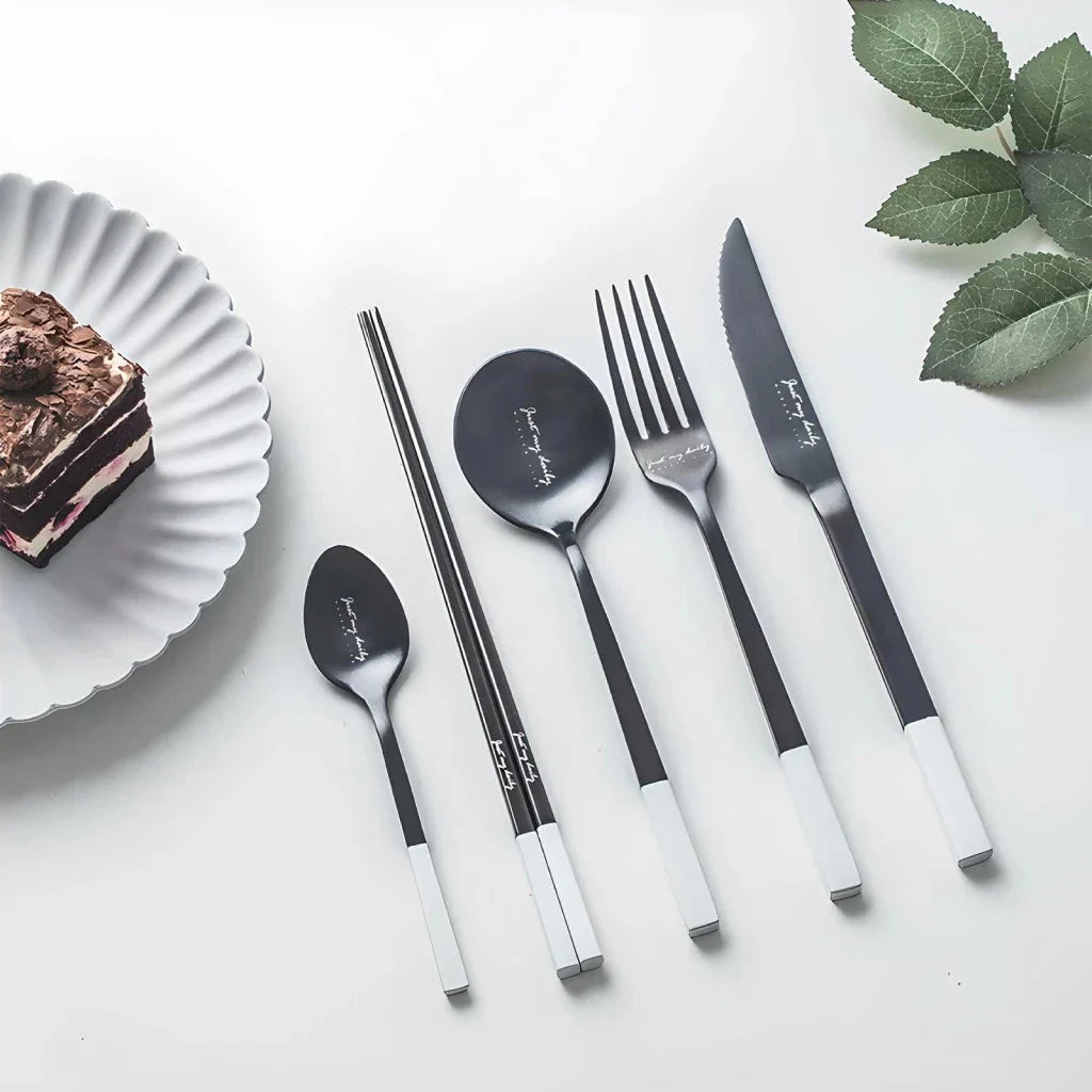 Elegant Nordic Stainless Steel Cutlery Set with a sleek black and white design, including knife, fork, spoon, and chopsticks