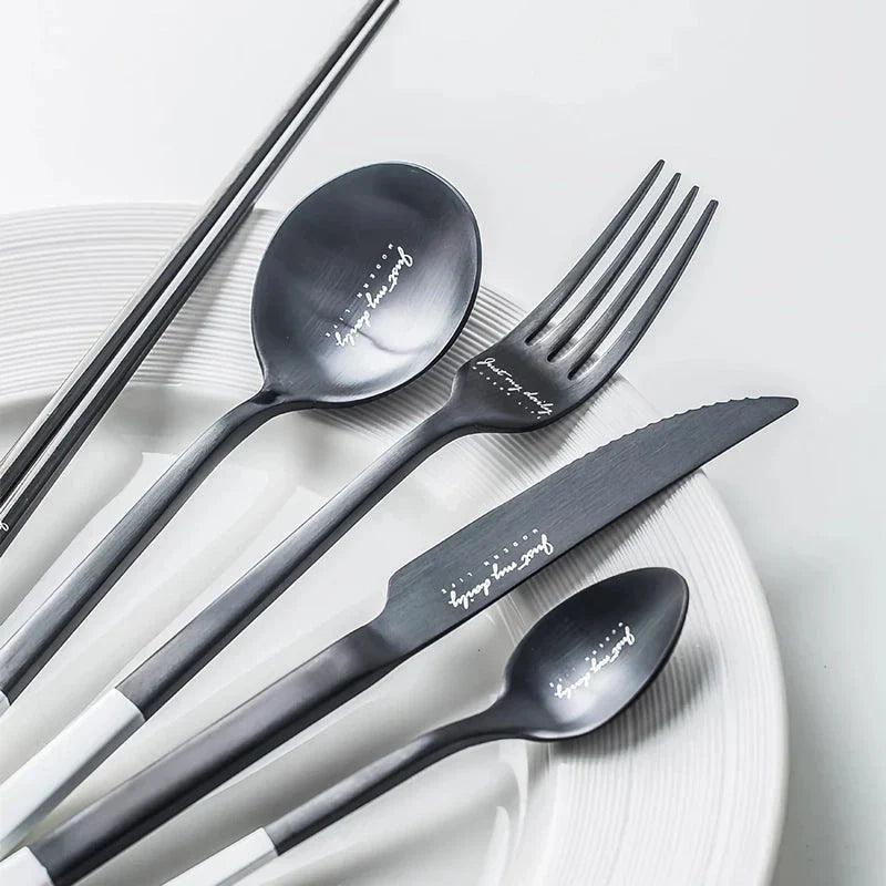 Elegant Nordic Stainless Steel Cutlery Set with a sleek black and white design, including knife, fork, spoon, and chopsticks